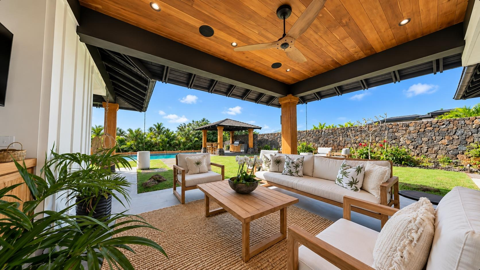 A covered patio opening onto a tropical garden, showing the connection between indoor and outdoor living.